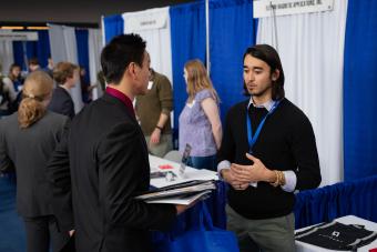 Daniel Liu (B.S chemical & biological engineering, MS in engineering and technology management, 2022) talks to Clayton Kramp (M.S. computer science 2019, B.S. applied math 2018) from Credera .
