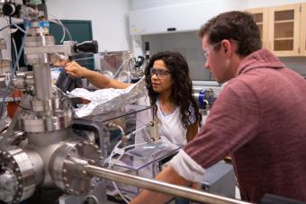 Physics Professor Meenakshi Singh in the lab with a student