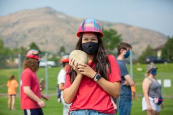 Mines student wearing a mask with her rock