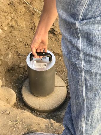 Person installing a seismometer