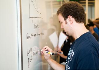Student working at a whiteboard