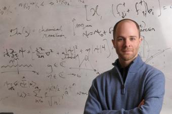 Lincoln Carr in front of a whiteboard with math