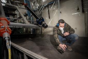 Josh Ehrlich works in a lab in McNeill Hall, testing DUSTEE