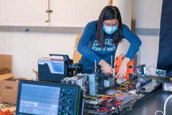 Student prepares for materials experiment in lab