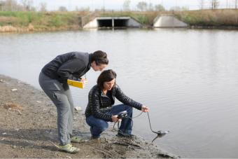 Terri Hogue and student take water reading