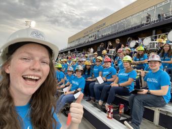 Jordan Weber in hard hat, posing with fellow marching band members