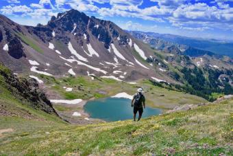 Bora looking into mountain valley with small lake at bottom