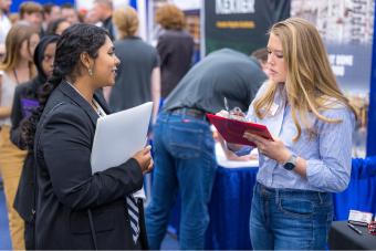 Mines student speaks to recruiter at Fall Career Day