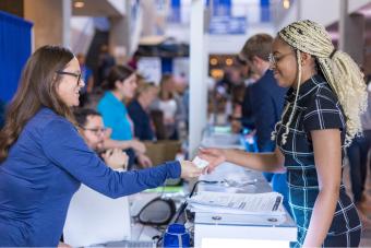 Student picks up name badge at Career Day