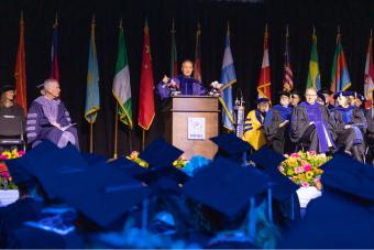 Ed Perlmutter speaks on stage at Mines Commencement