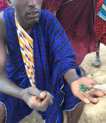 Gemstone trader in Tanzania displaying stones