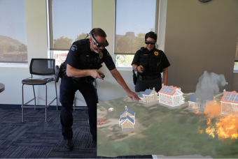 Two police officers conduct a virtual tabletop exercise