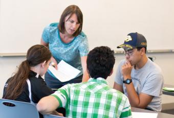 Becky Lafrancois interacts with students in economics class