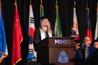 Student speaker at podium at undergrad commencement