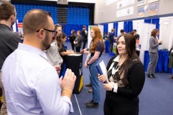 Alison Giachino, a senior studying chemical engineering, speaks to JR Hudnall '09 about job openings at Kiewit.