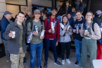 Students pose with barrel mugs