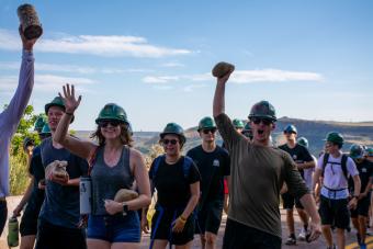 students holding rocks during 2023 m climb