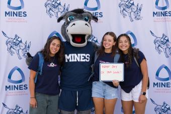 students pose with mascot Blaster