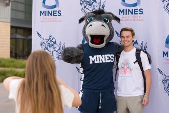 student poses with blaster