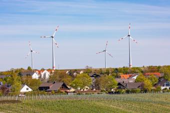 wind turbines in background with homes in foreground