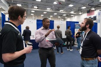 student talks to two recruiters