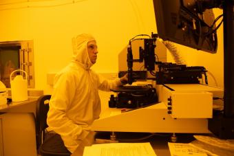 Male student works in quantum clean room