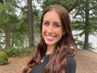 Woman smiling in front of trees