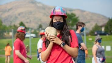 Mines student wearing a mask with her rock
