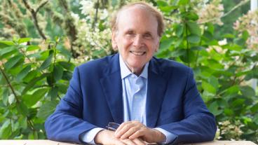 Daniel Yergin seated at a table