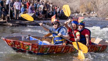 Students paddle during 2024 Cardboard Boat Race