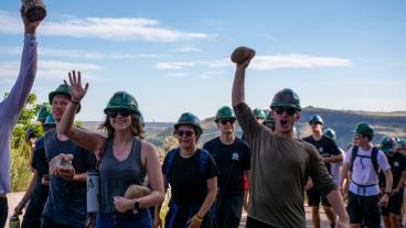 students holding rocks during 2023 m climb