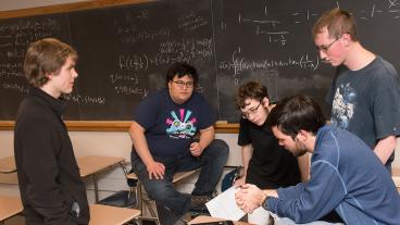 Mines student Sam Reinehr, second from left, works with fellow students to prepare for the William Lowell Putnam Mathematical Competition.