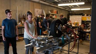 Mines students work on the DiggerLoop pod in the garage.