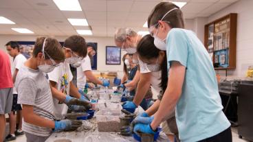 Students mix concrete at Tunnel Camp at Mines