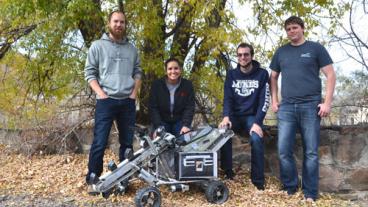 Seniors Marc Allen, Megan Salinas, Ryan Stauffer and Kevyn Young pose around the lunar mining rover.