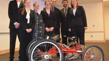Mines senior design team, CSM FourCross, with their quadriplegic bike.