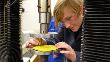 Mechanical engineering student Emma Gray tests one of the competitor pads for energy absorption.