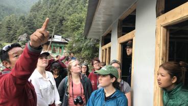 Lhakpa Sherpa, founder of Hike for Help, explains to Mines students the construction of Hike for Help's workshop for the Dalit to produce and sell their handicrafts