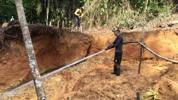 Artisanal miners use water pressure hoses to access a gold vein deep in the jungle in Bajo Cauca, Colombia.