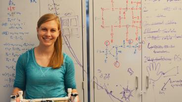 Mechanical engineering student Alexis Humann with the robot she is building as part of her undergraduate research fellowship. Humann will be working on building another robot at the Arecibo Observatory this summer.