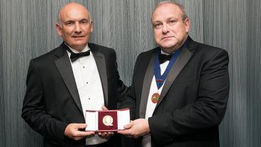 John Speer, left, is presented with the Bessemer Gold Medal by IOM3 President Martin Cox.