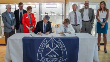 Mines President Paul Johnson and U.S. Geological Survey Director Suzette Kimball signing a document renewing the five-year memorandum of understanding.