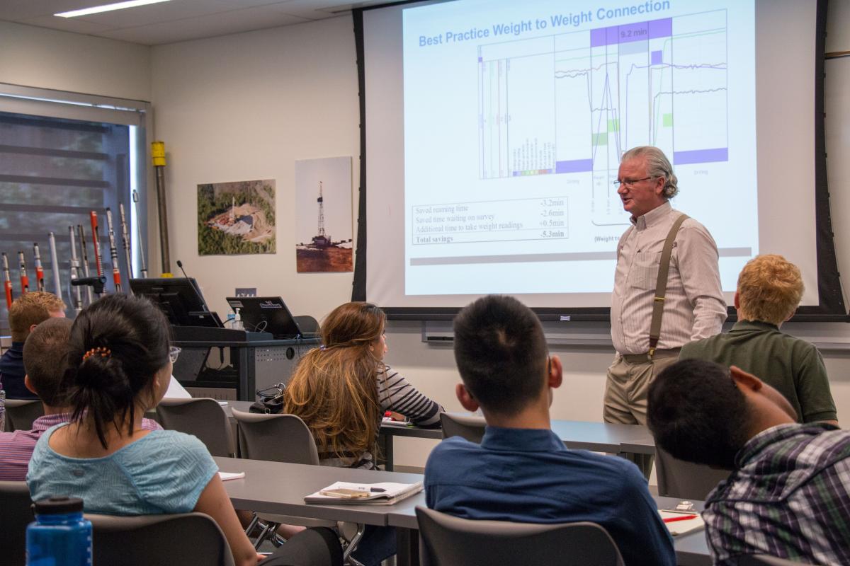 Students in Drilling and Production Data Analytics externship learn from industry rep John de Wardt.