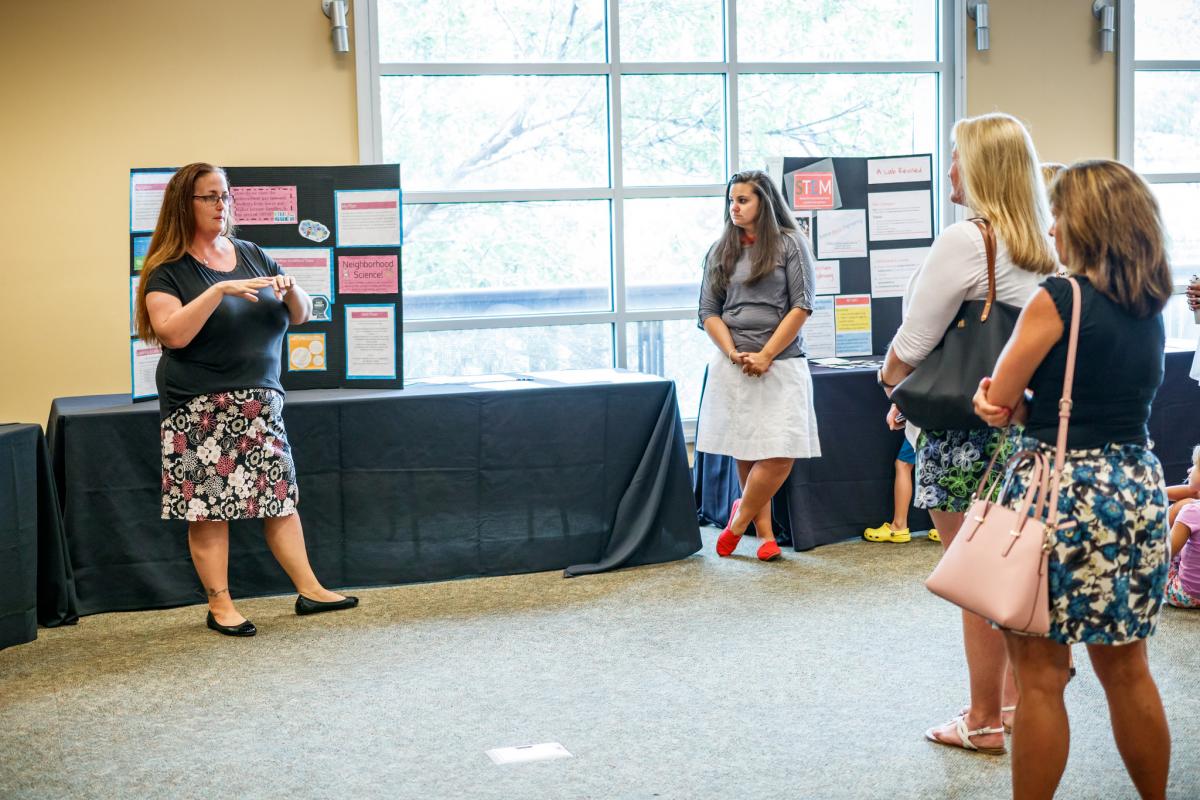 Teachers present what they've learned at the final poster showcase.